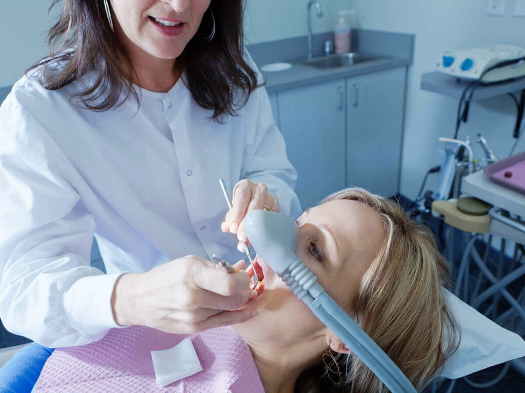 doctor using sedation dentistry on patient