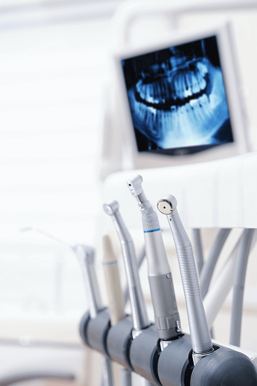 dental tools with x ray in the background
