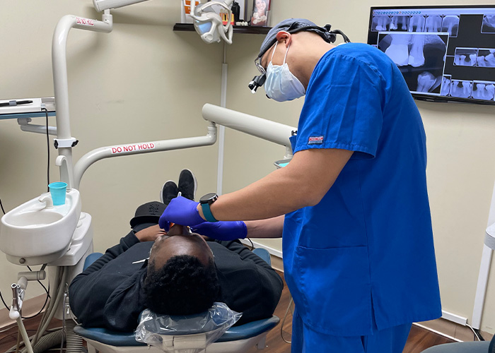 Dr. Magalona examining patient in chair