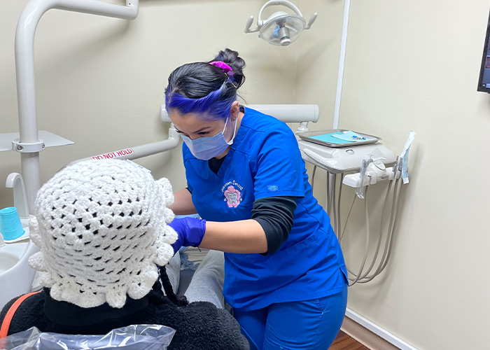 Assistant working on dental patient