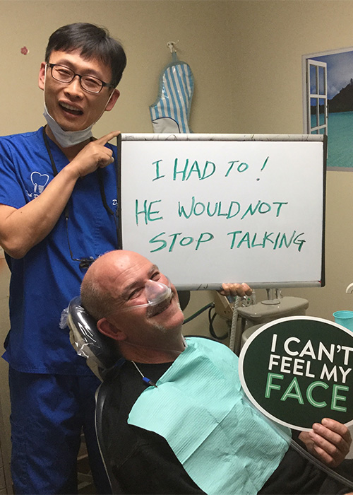 Dr. Pak with patient and funny sign